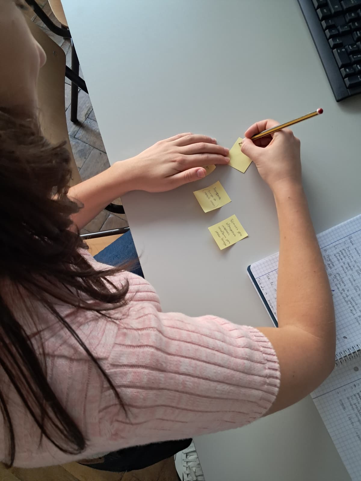 Team member writes observations on sticky notes during the session.